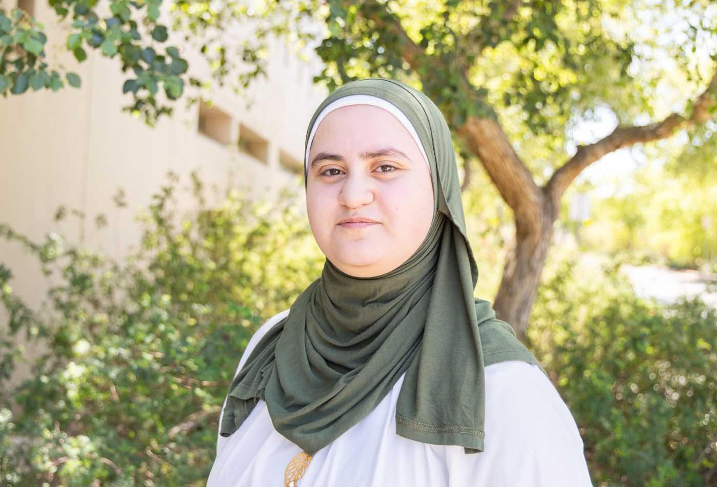 ASU student poses wearing a pale green hijab, highlighting the field explored in the certificate in Islamic Studies.