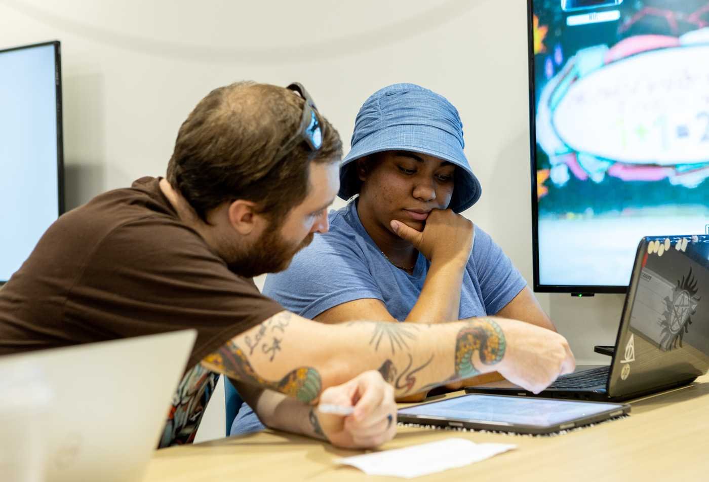 Students collaborate around a laptop, developing language skills in ASU's Italian, BA program.