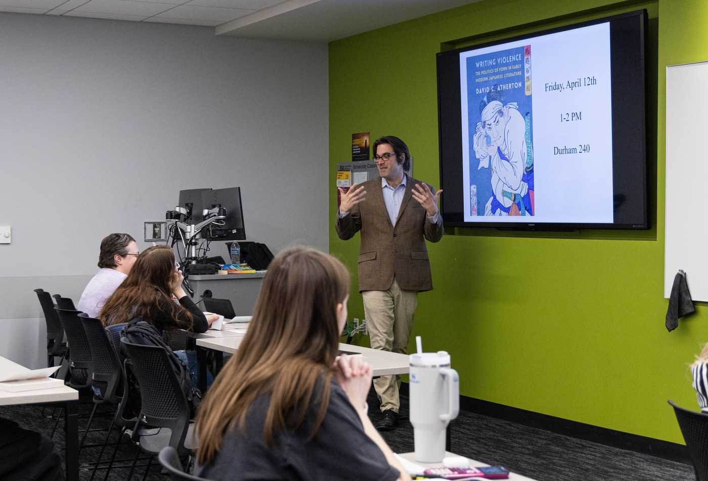 A professor speaking to a large class of students in his Japanese course, demonstrating the student experience in the Asian Languages/Civilizations (Japanese).