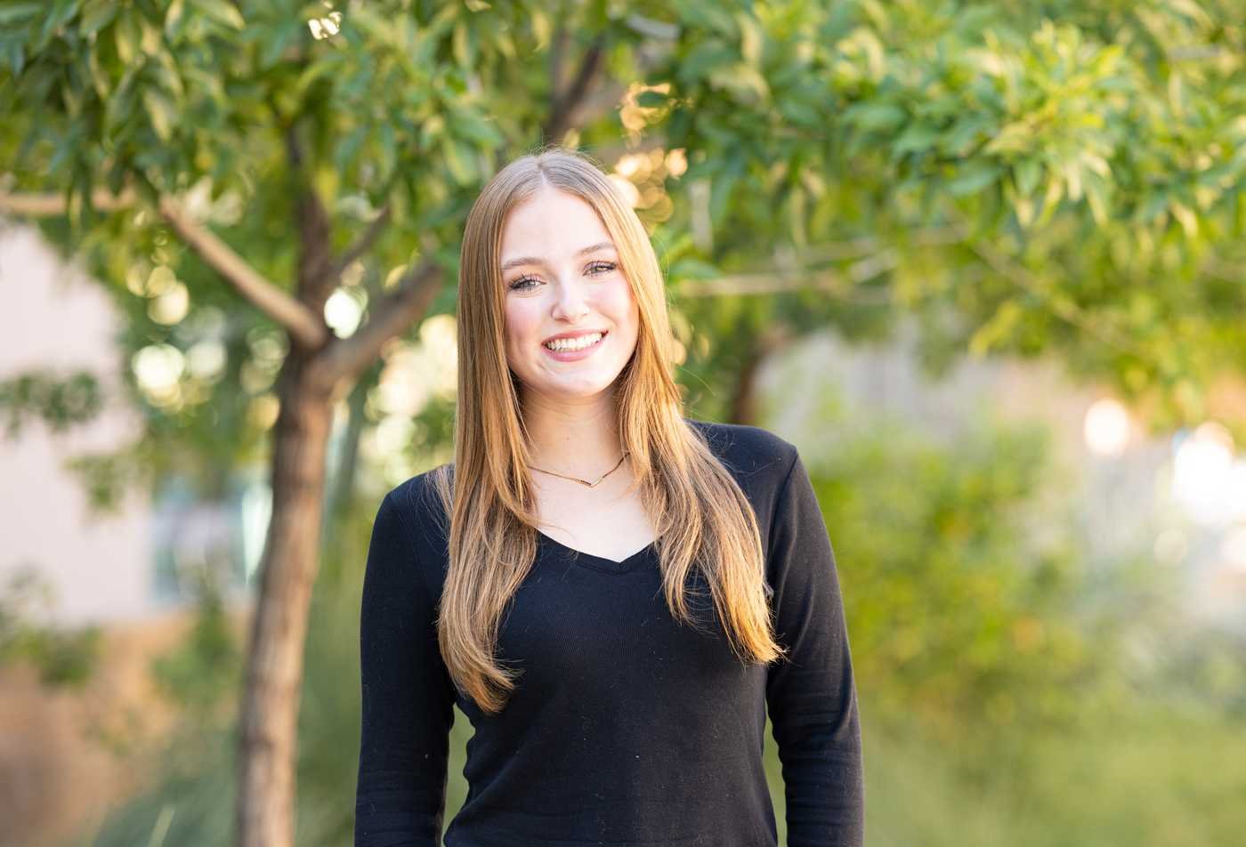 A student poses outdoors on campus, connecting society and justice in ASU's Justice Studies, BS program.