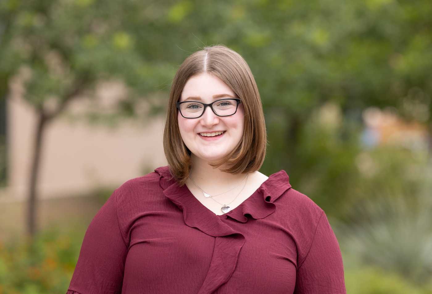 A justice studies student smiles outside on Tempe campus, developing her understanding of society in the minor in Justice Studies.