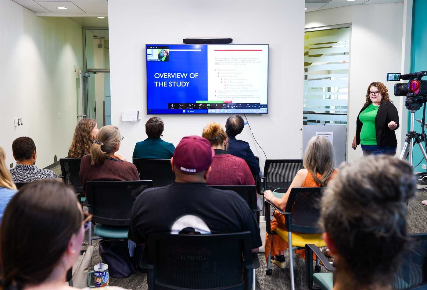A student gives a presentation to a small audience, demonstrating expertise gained in the Linguistics and Applied Linguistics, PhD.