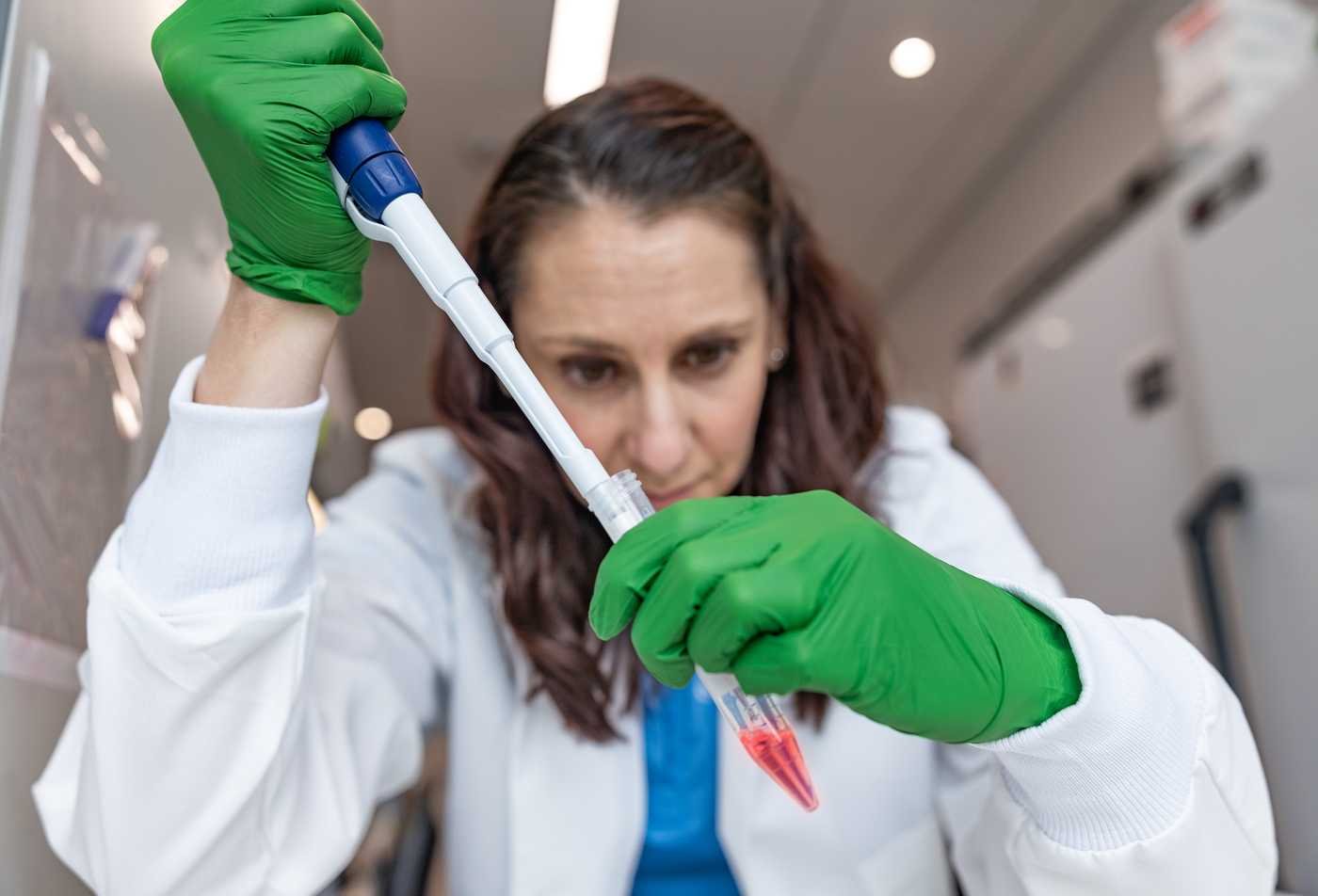 A research works in a laboratory, advancing discovery in ASU's Molecular Biosciences and Biotechnology, BS program.