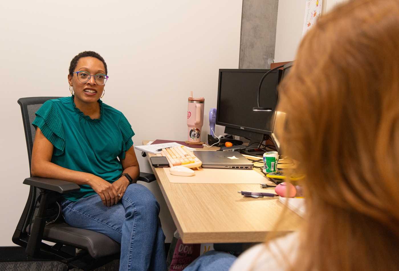 A faculty member meets one on one with a student, showcasing the collaborative learning environment in the Marriage and Family Therapy, MAS.