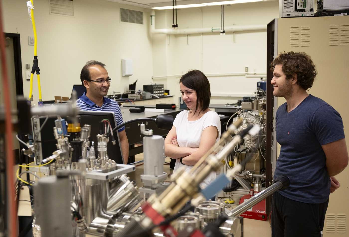 Students examine scientific equipment, demonstrating hands-on learning in the minor in Physics.