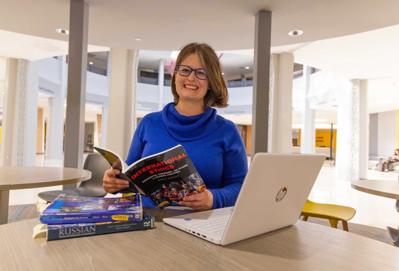 A student studies a book on international ethics, showcasing the field explored in Political Science, MA.