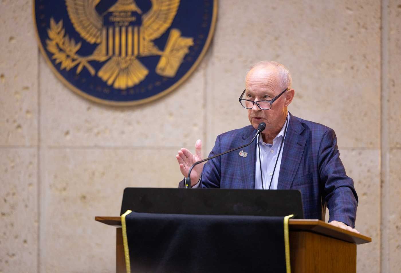 A speaker addresses an audience, demonstrating language expertise in the minor in Portuguese.