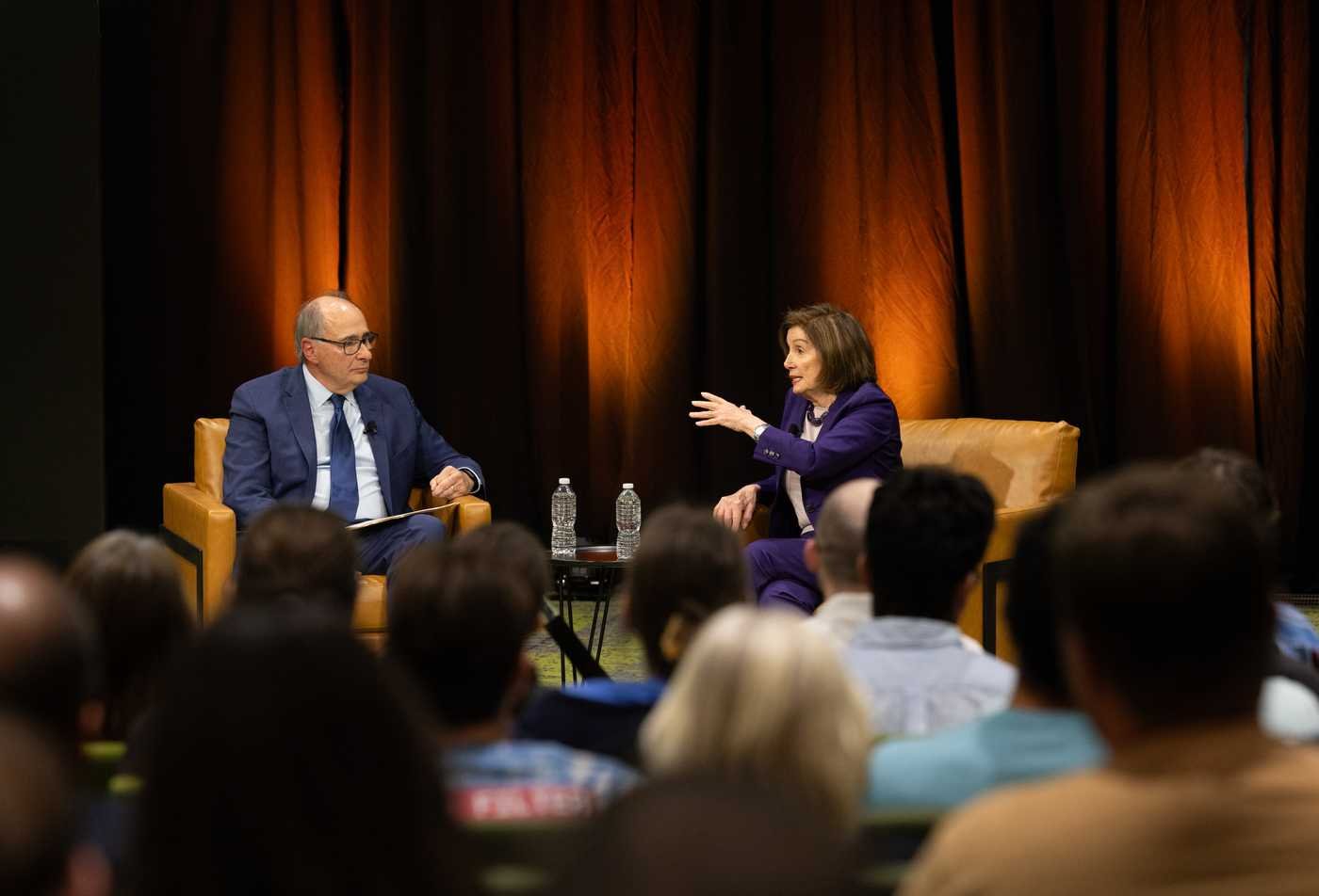 Two speakers discuss public affairs before an audience, reflecting civic dialogue in ASU's Political Science, BA program.