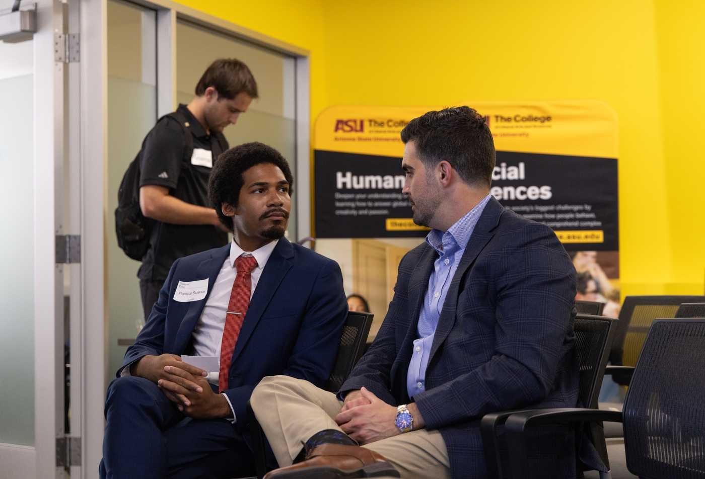 Two speakers sitting in chairs at a speaking event for political science students, showcasing the hands-on learning in the Political Science (Political Analytics), MA.