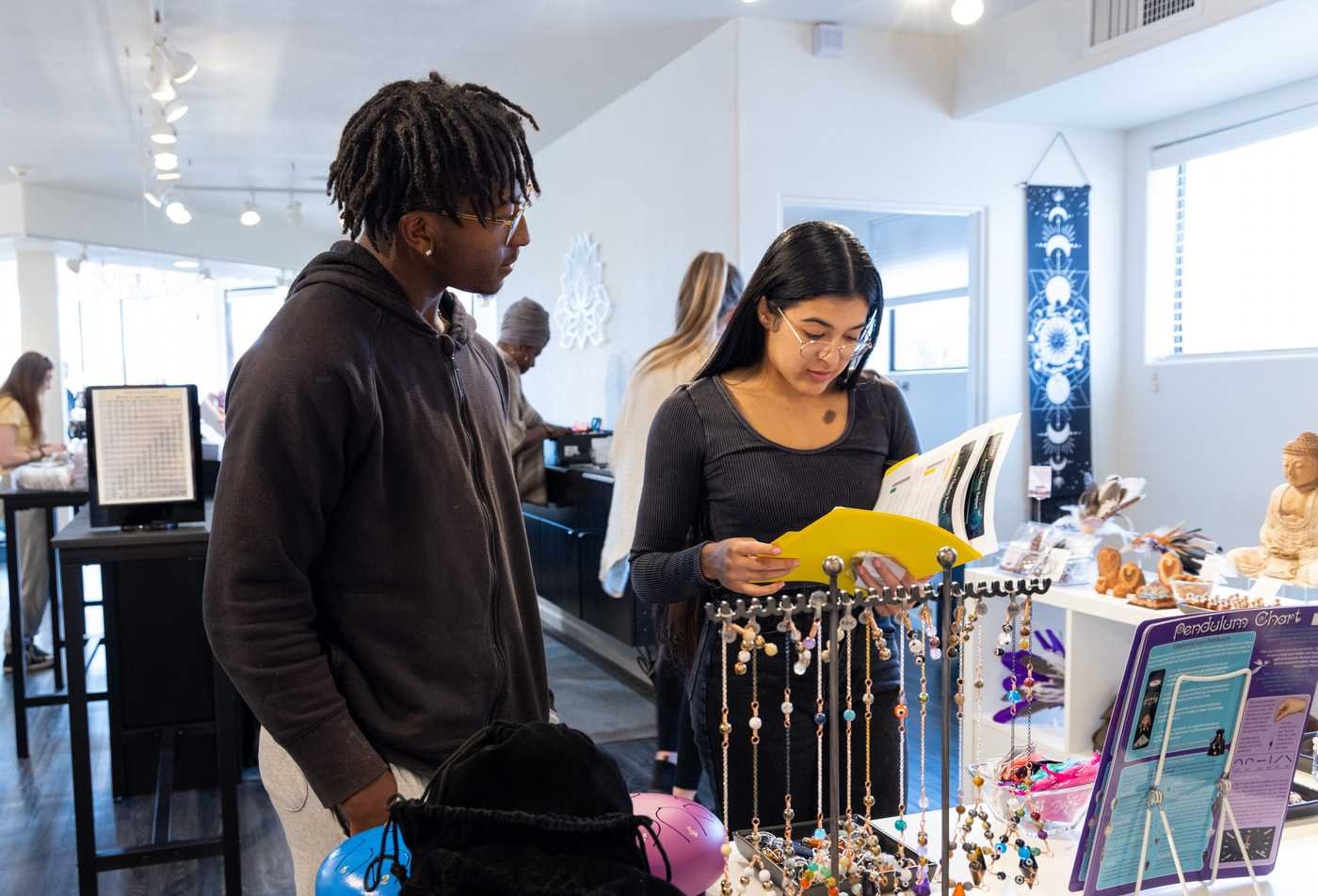 Students explore spiritual items in a shop, examining belief and culture in ASU's Religious Studies (Religion, Culture and Public Life), BA program.