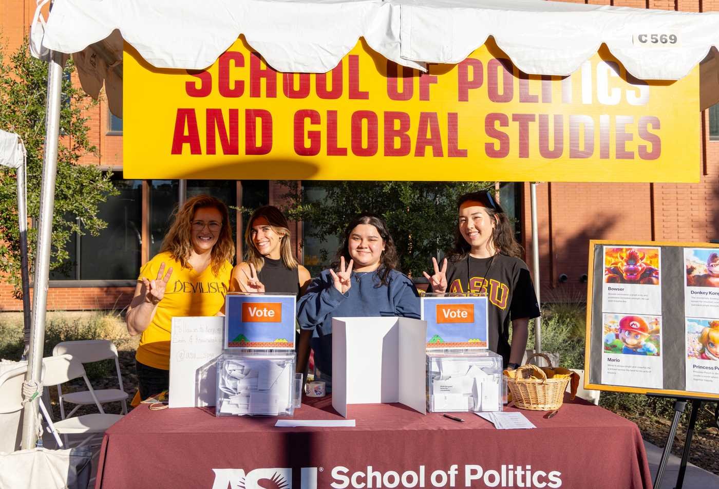 Students staff a campus booth for the School of Politics and Global Studies, exploring civic engagement in ASU's Global Studies, BA program.