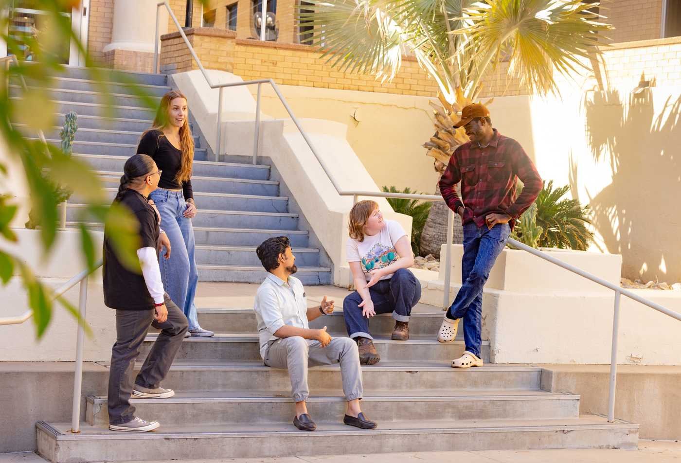 Students in the School of Human Evolution and Social Change talk together on steps at Tempe campus, showcasing the collaborative environment in the minor in Global Studies.