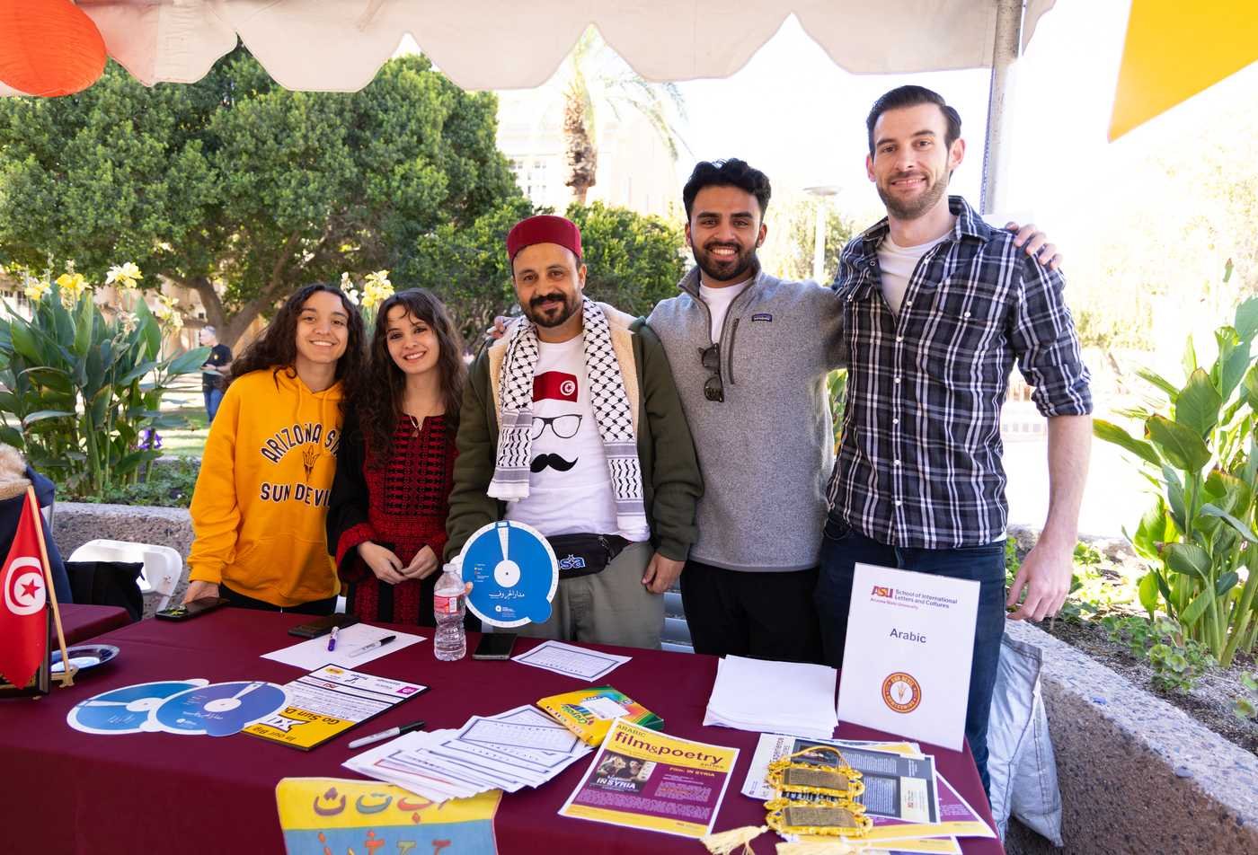 Students staff an Arabic cultural table, exploring heritage in ASU's International Letters and Cultures (Arabic Studies), BA program.