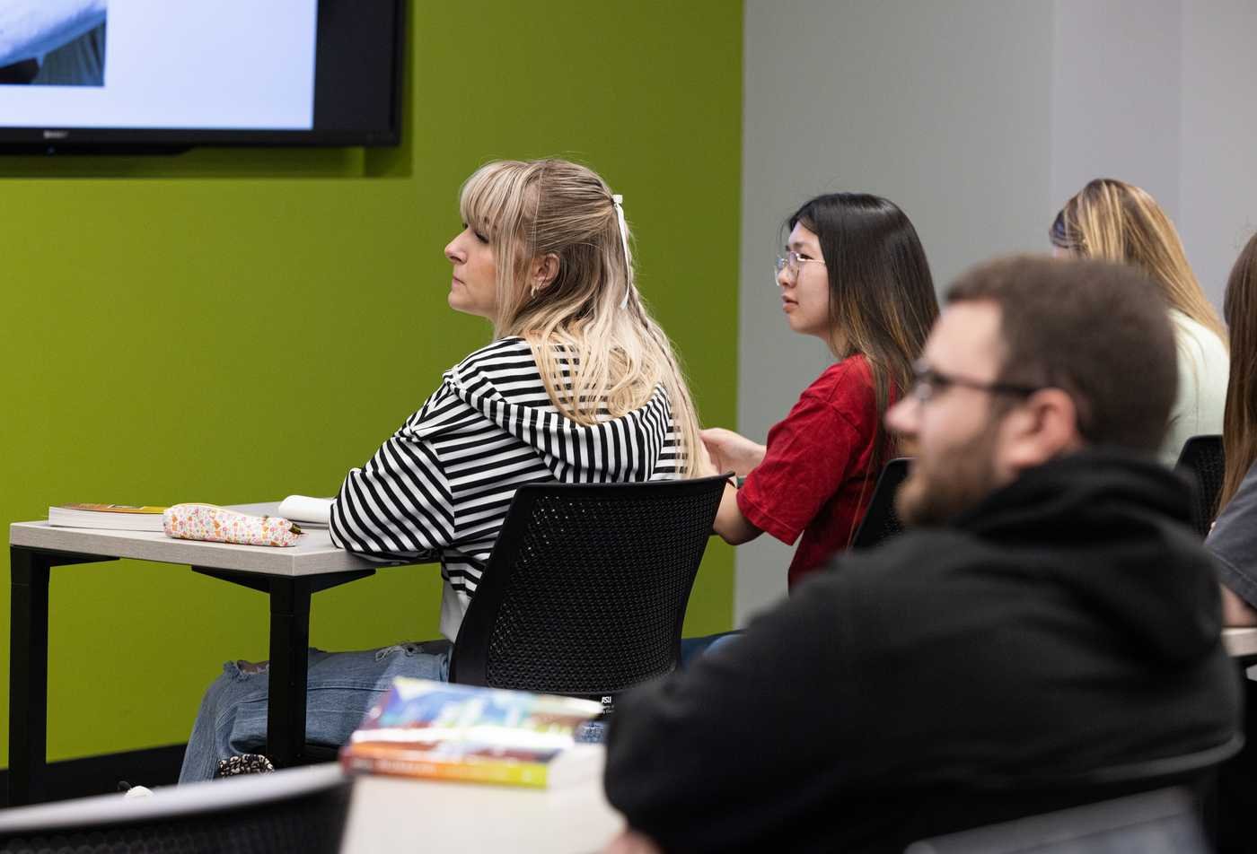 Students listen attentively during a lecture, showcasing collaborative learning in the minor in Slavic Studies.