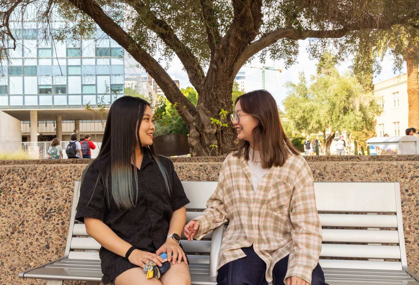 Students discuss sociology together outside, showcasing collaorative learning in the BS in Sociology.