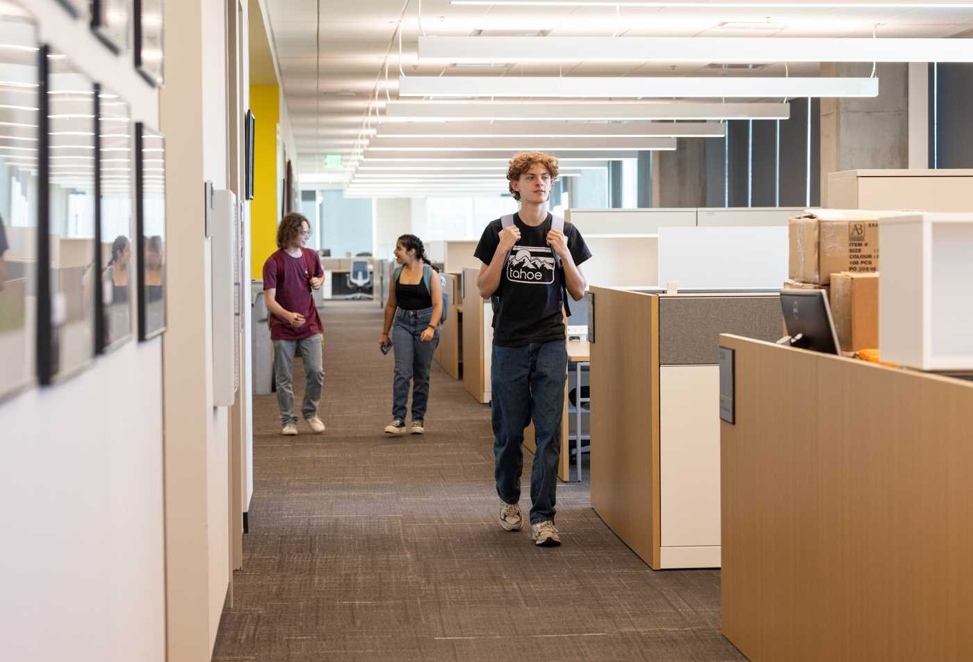 Students walk around an office environment, showcasing the expertise in the Sociology, MA.