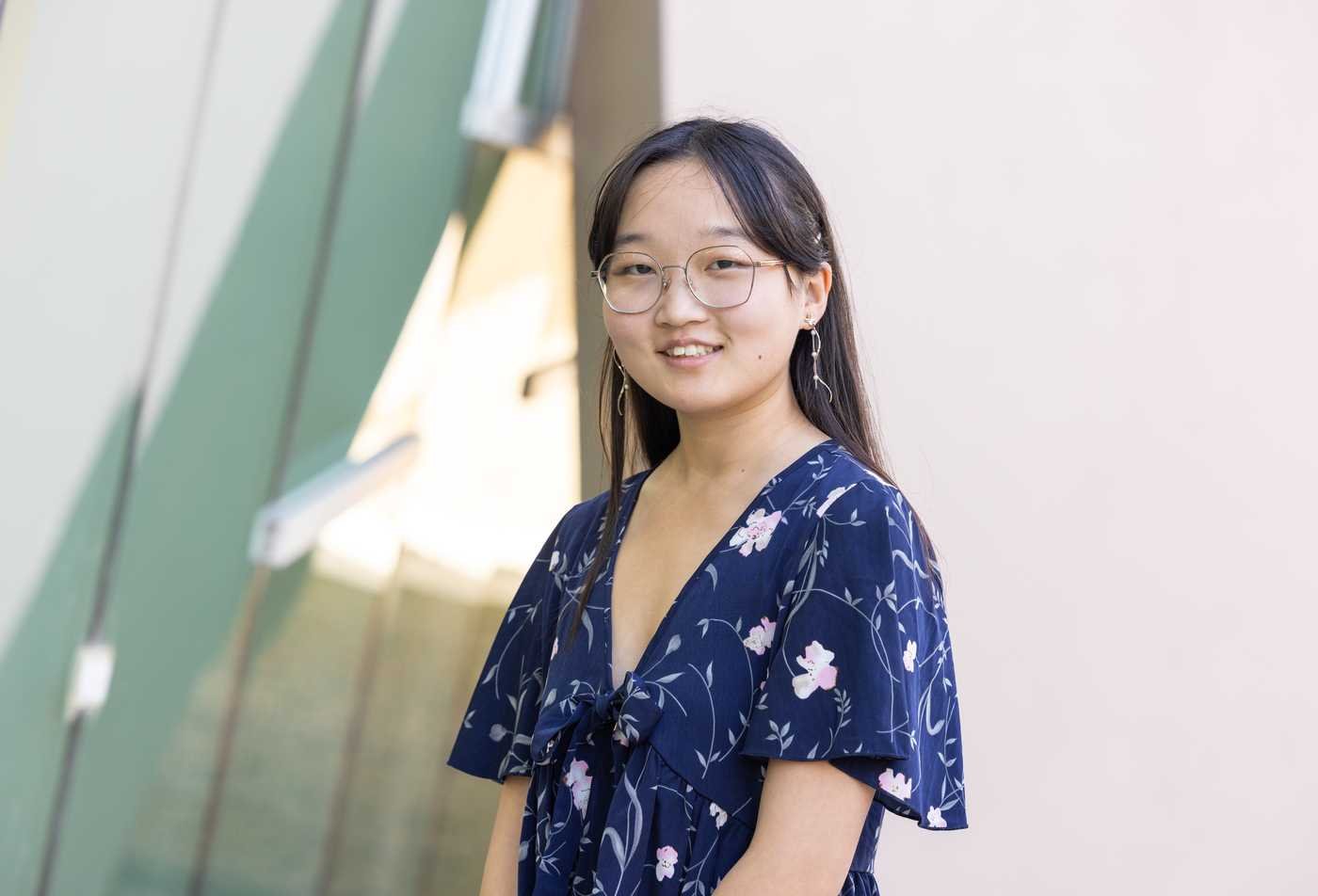 A student poses outside on university campus, symbolizing expertise gained in the Sociology, PhD.