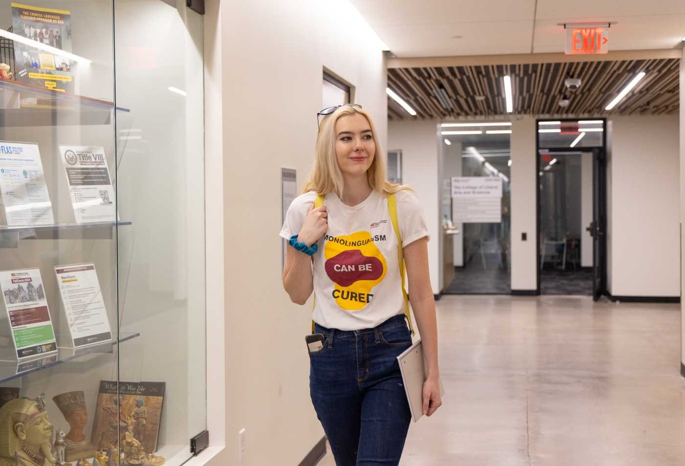 A student wears a shirt that says "Monolingualism can be cured." highlighting the value of the Spanish Linguistics, PhD.