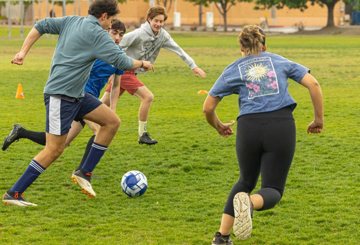 Four students play soccer on the Tempe Campus, demonstrating the field explored in the certificate in Sports, Cultures and Ethics.