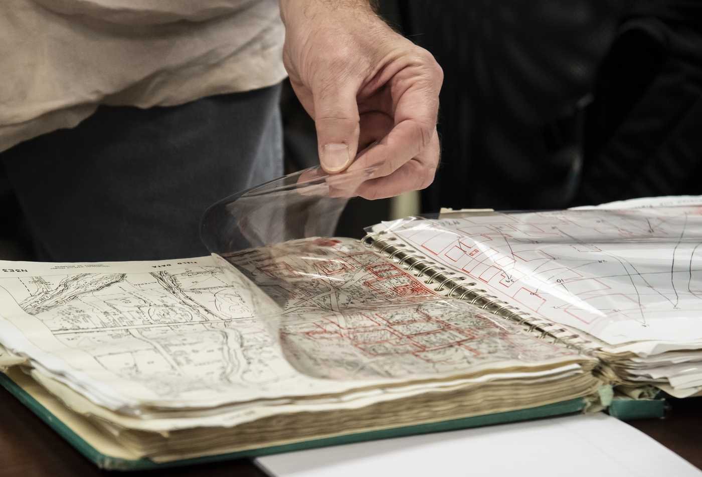 A student examines an old map, showcasing hands-on learning in Social Science Research Methods.