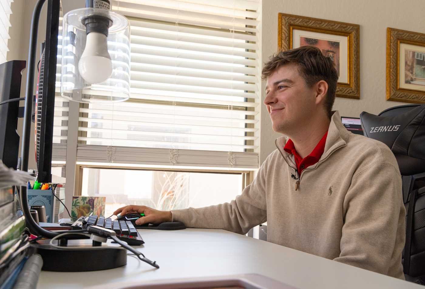 A student works on a computer at home, demonstrating flexible learning in the MS in Applied Statistics and Data Science.