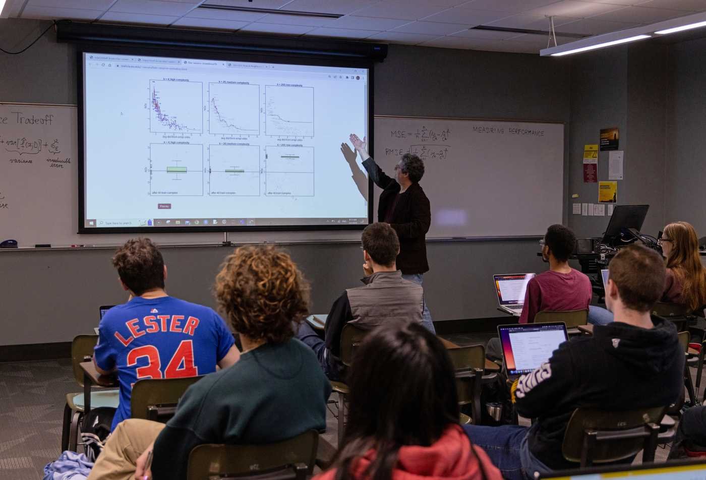 A professor explains statistics to a listening class, showcasing hands-on learning in the minor in Statistics.