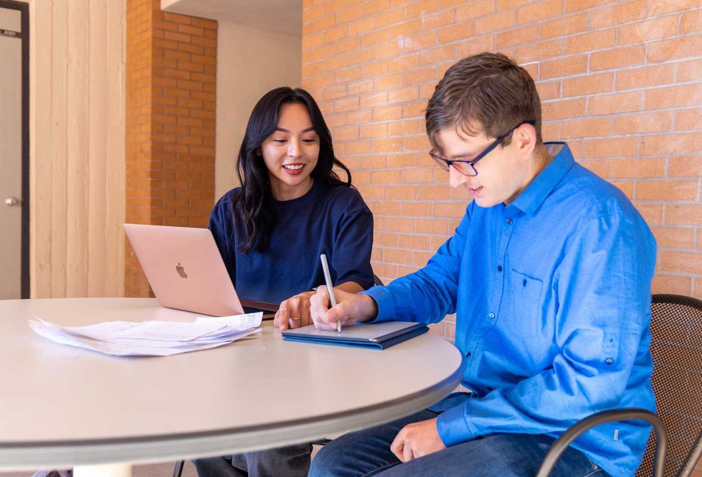 Two students study together on the university campus, showcasing collaborative learning in the Statistics, PhD.