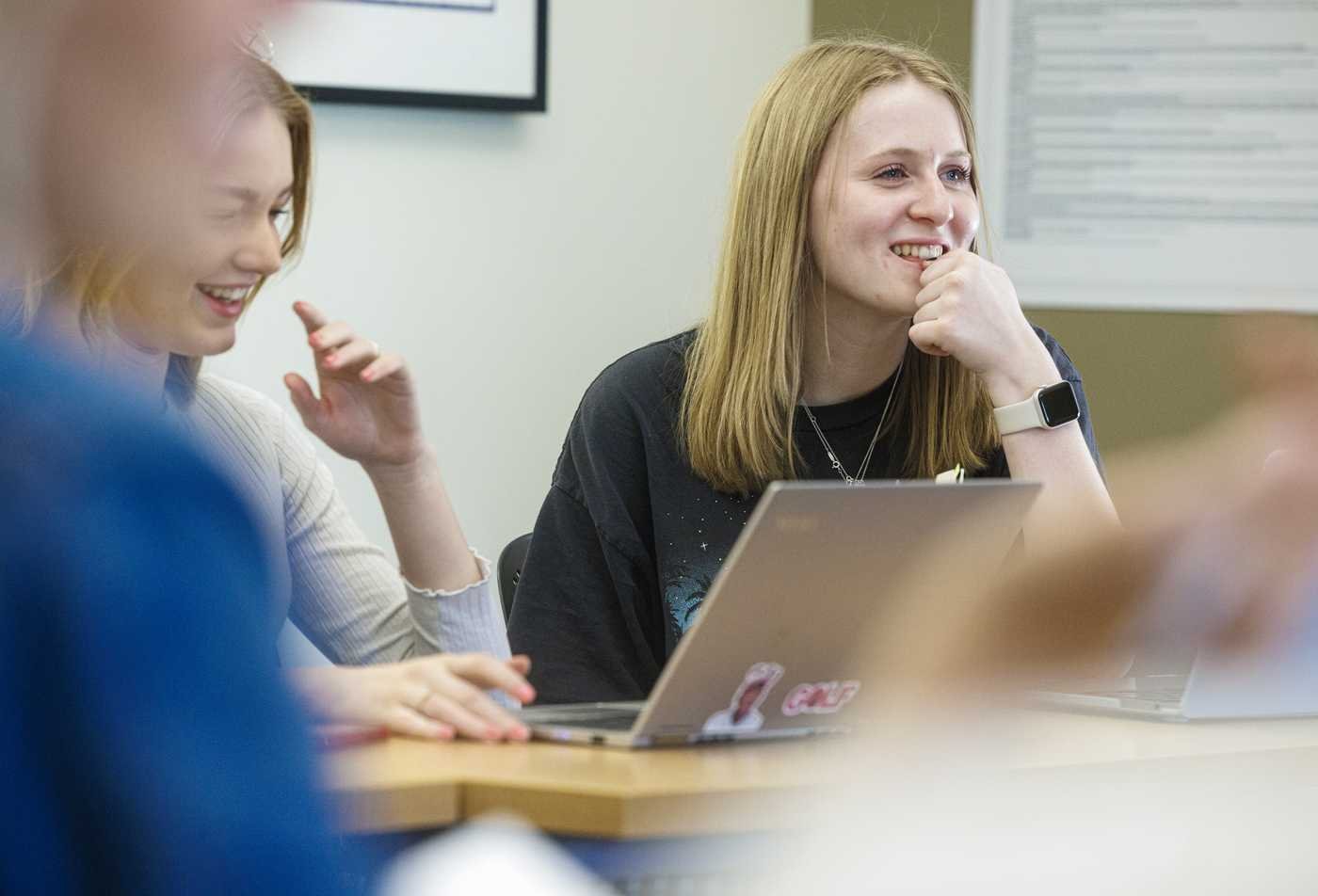 Students discuss ideas around a laptop, exploring identity in ASU's Gender, Women and Sexuality Studies, BA program.