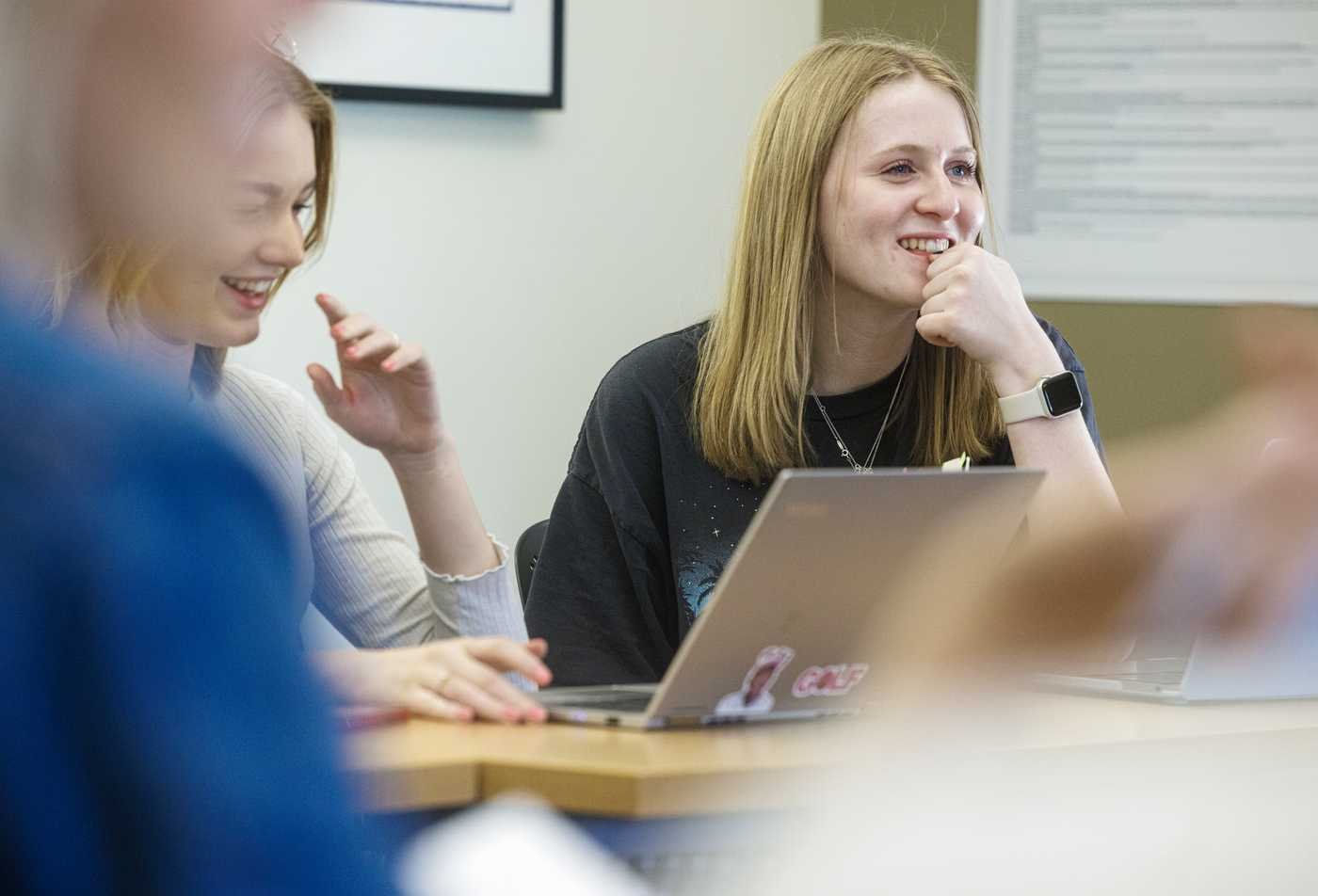 Students discuss ideas around a laptop, exploring identity in ASU's Gender, Women and Sexuality Studies, certificate program.