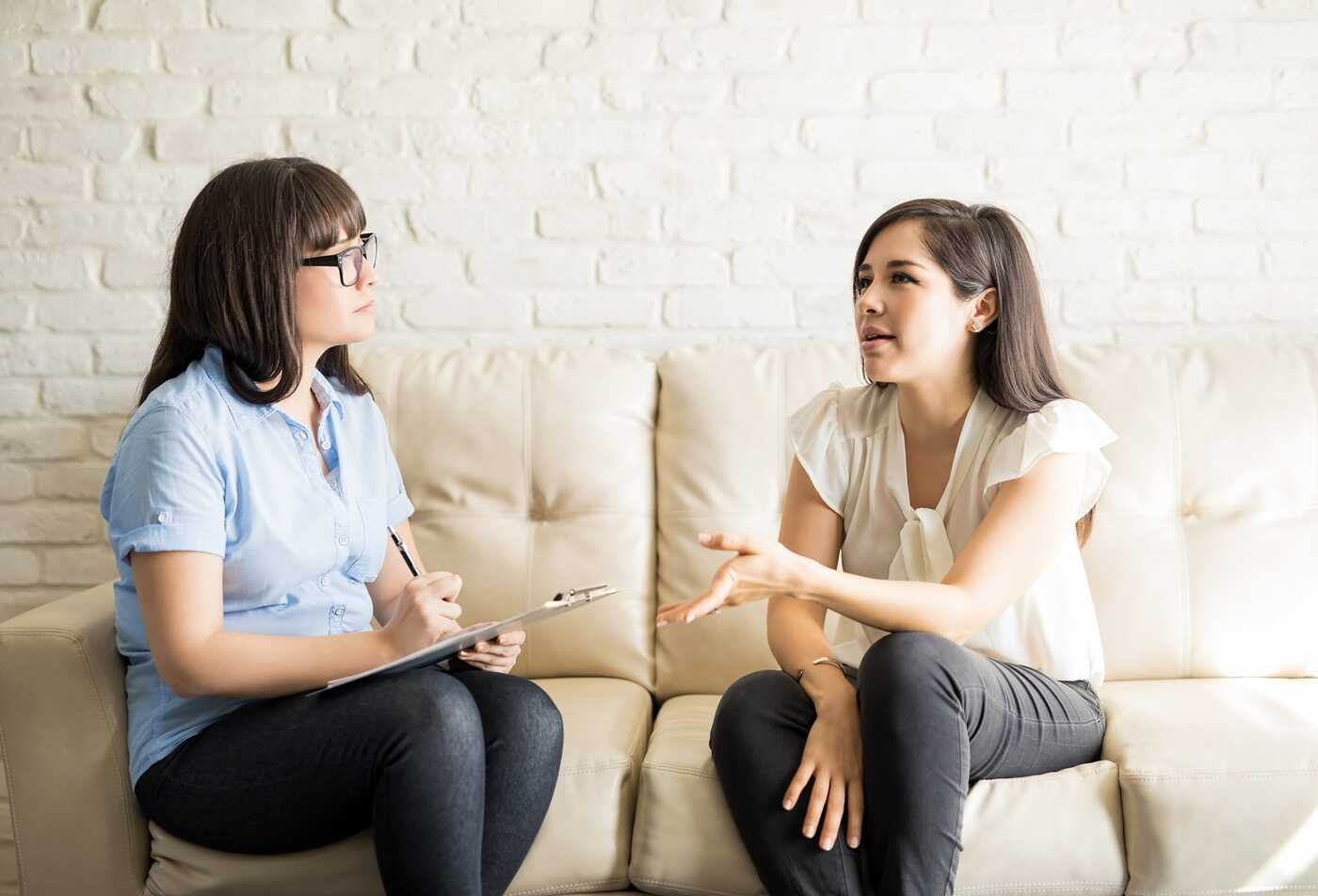 A counselor meets with a client in a private setting, highlighting the supportive practice explored in ASU's Counseling, MC program.
