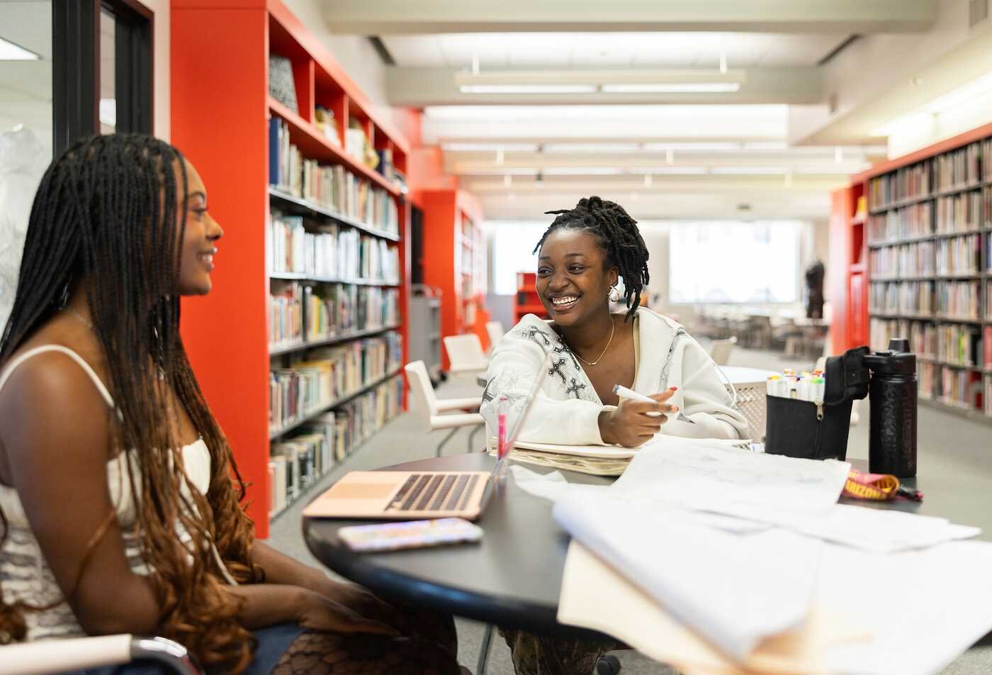 Students collaborate in a library, reflecting broad academic exploration in ASU's Liberal Studies, BA program.