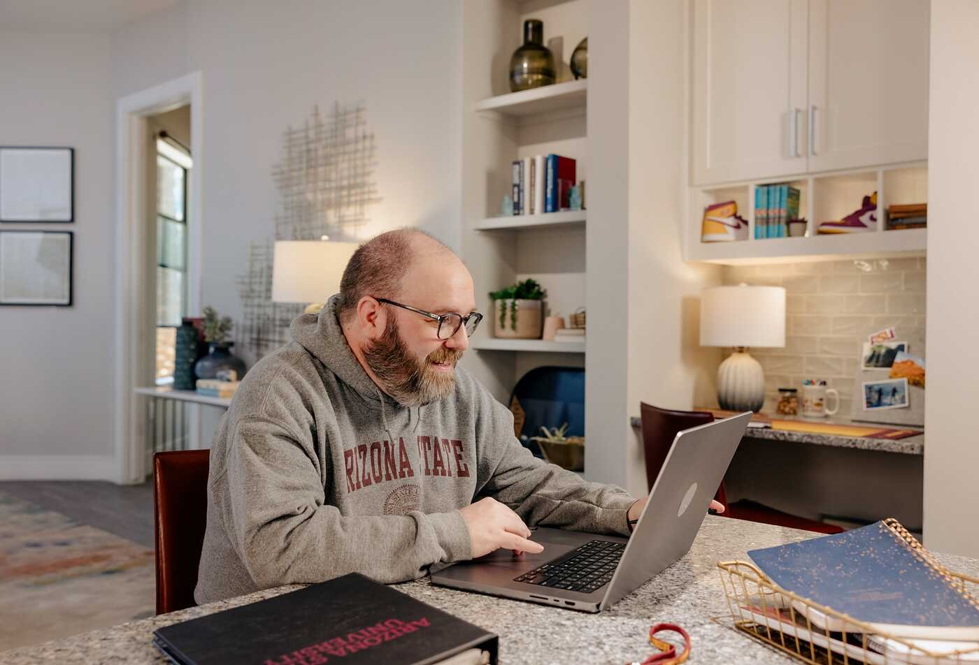 A learner works on a laptop at home, supporting interdisciplinary study in ASU's Liberal Studies, MLSt program.