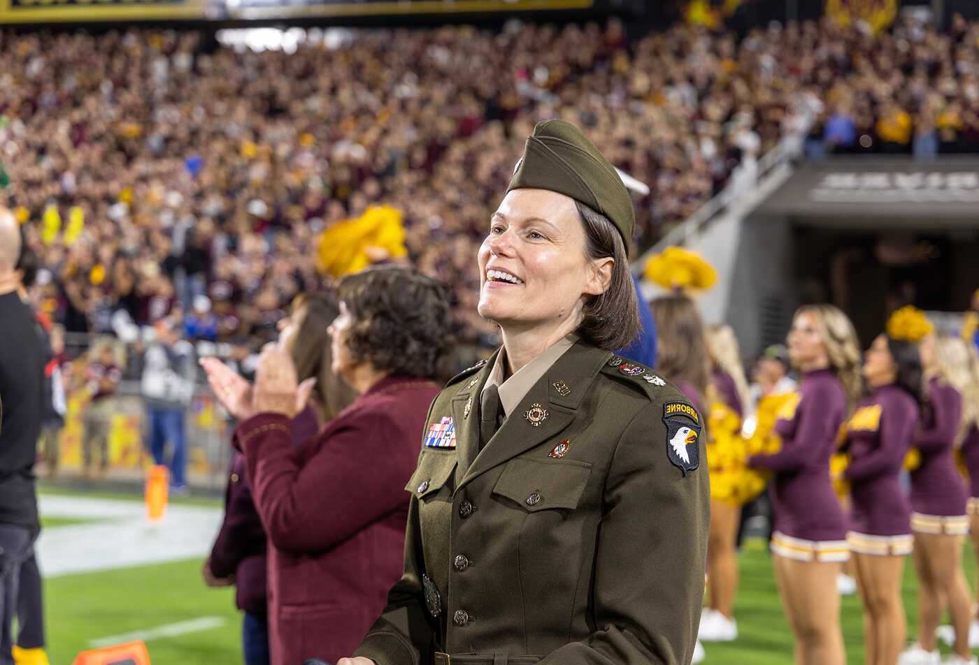 A service member smiles before a stadium crowd, highlighting practical application in ASU’s Applied Military and Veterans Studies program