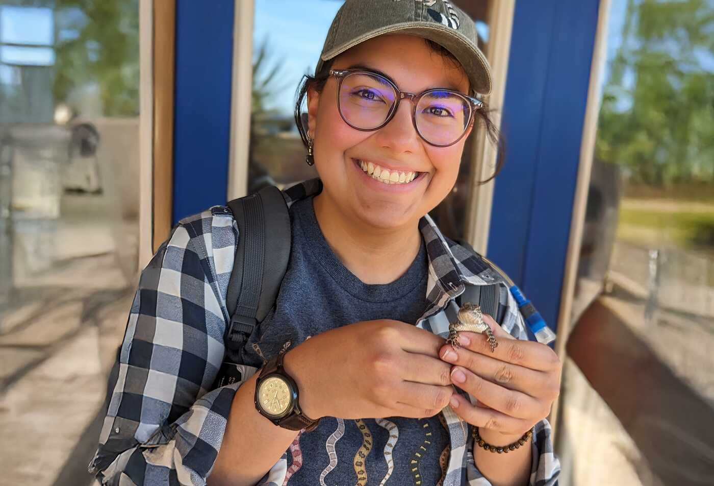 Holding a small lizard, a student gains hands-on experience relevant to ASU’s Applied Science in Animal Biology program