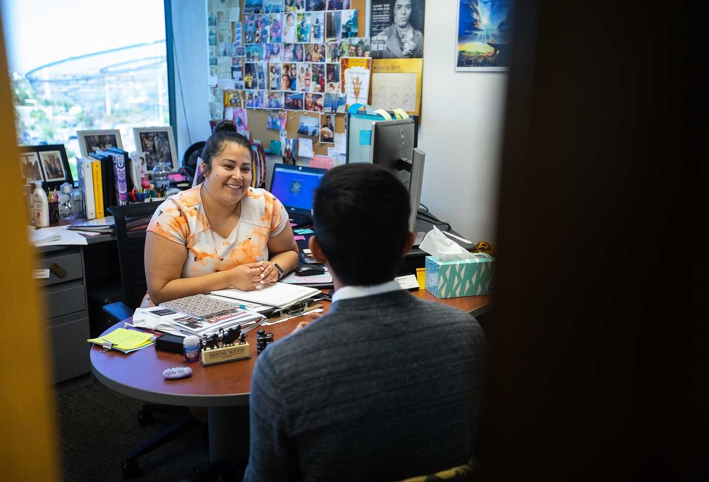 A counselor meets with a student in an office, reflecting supportive guidance in ASU's Counseling (School Counseling), MC program.