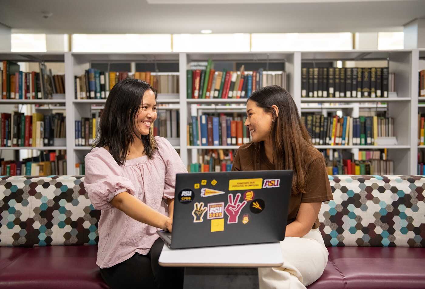 Students discuss research in a library, reflecting historical inquiry in ASU's History minor.