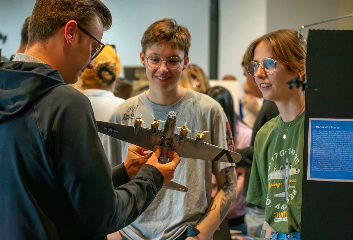Students examine a model aircraft, reflecting technological history in ASU's History of Science, Technology and Innovation minor.