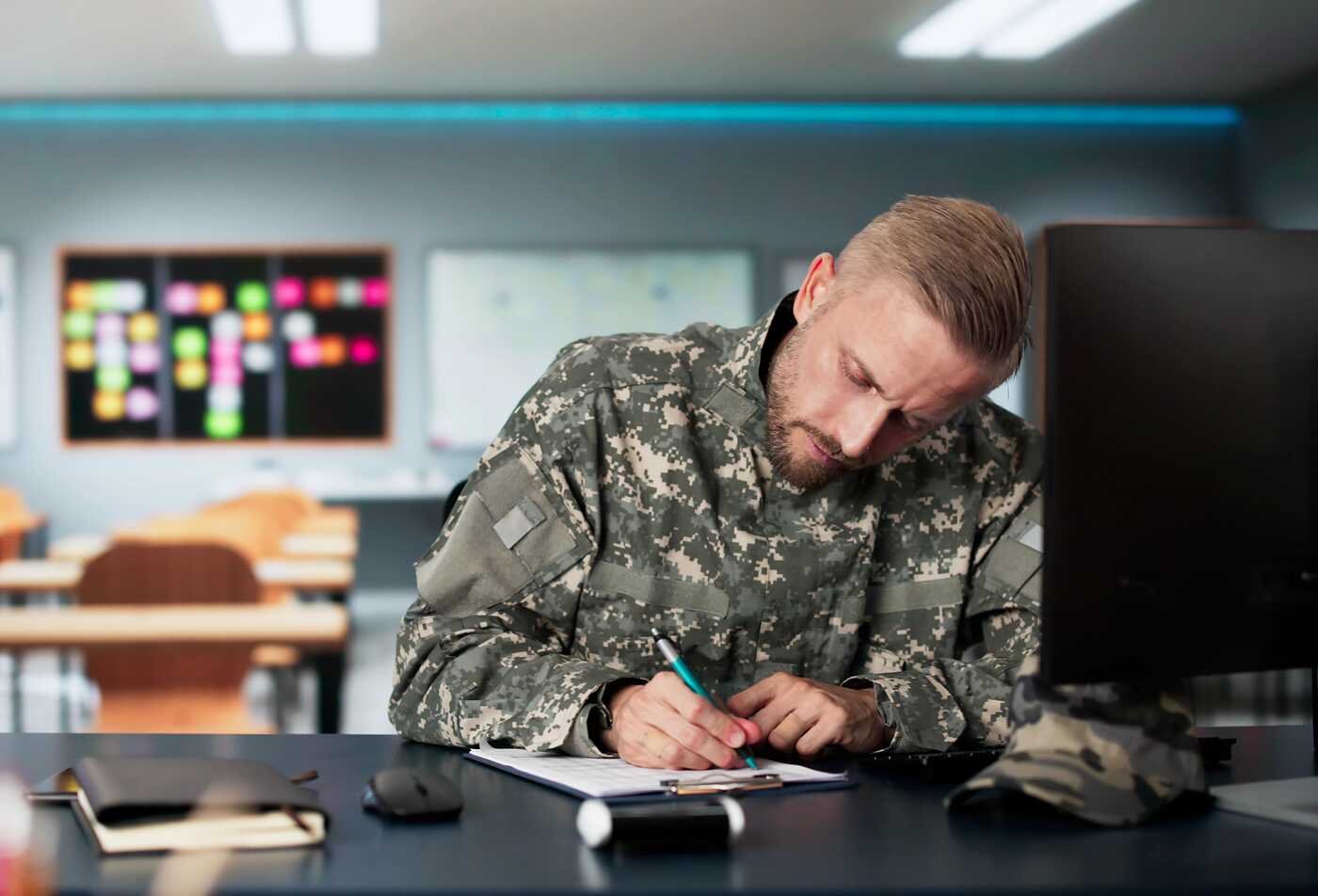 A service member studies at a computer, gaining skills through ASU's Organizational Leadership (Military and Veterans Studies), BA program.