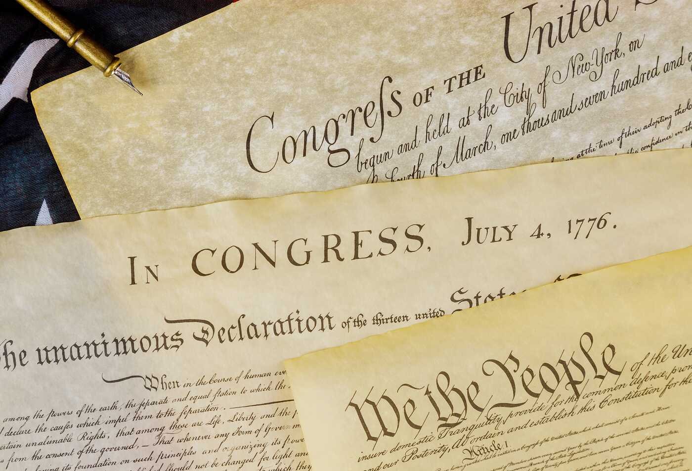 Historic U.S. documents lay on a table, representing the government and civic institutions studied in ASU's Political Science, BS program.