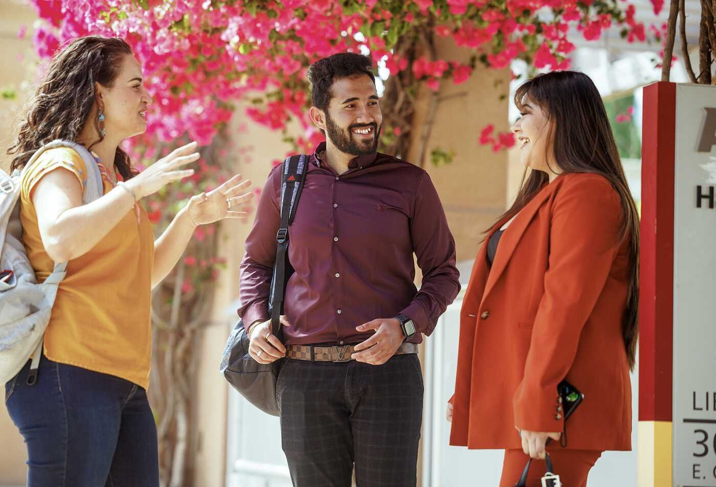 Professionals talk outdoors, reflecting workplace language skills in ASU's Spanish for the Professions certificate.