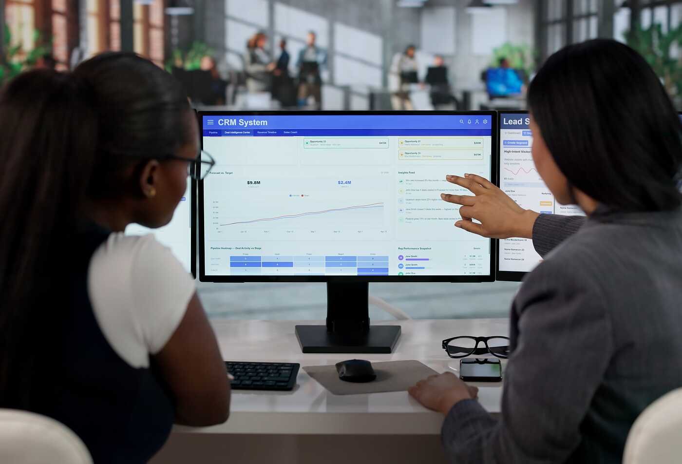 Two professionals review data dashboards together, demonstrating clear data communication in ASU’s Applied Science in Technical Communication program.
