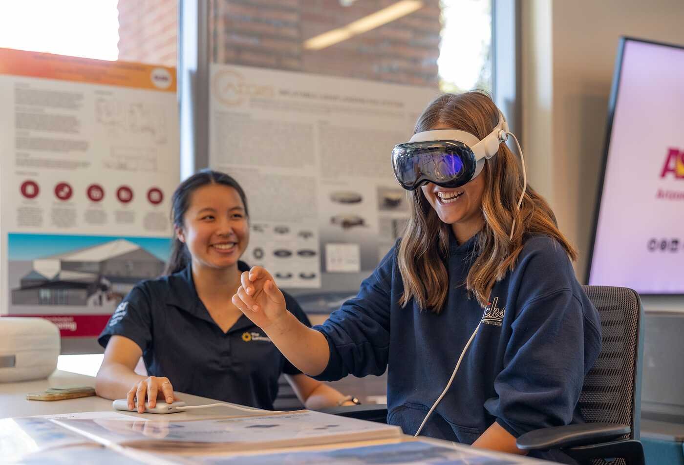 A student uses a virtual reality headset, exploring digital communication in ASU's Technical Communication, BS program.