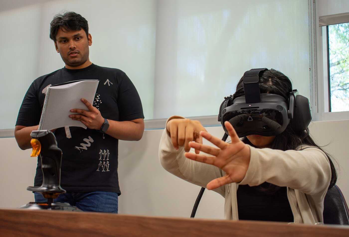 A student tests a virtual reality interface, exploring user-centered design in ASU's Technical Communication (User Experience), BS program.
