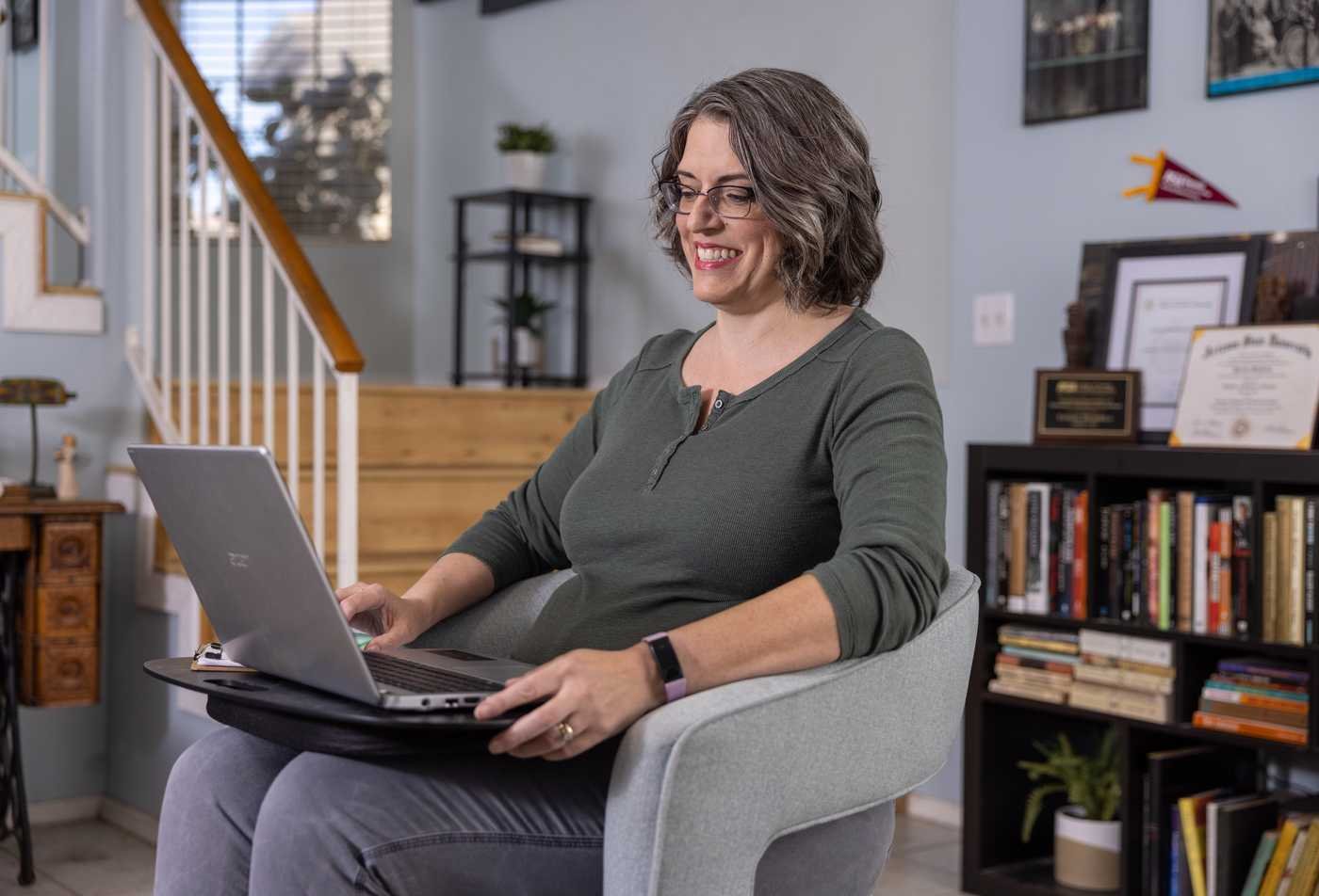 An aging graduate student completes coursework on a laptop, representing the population served by the Aging, MS.