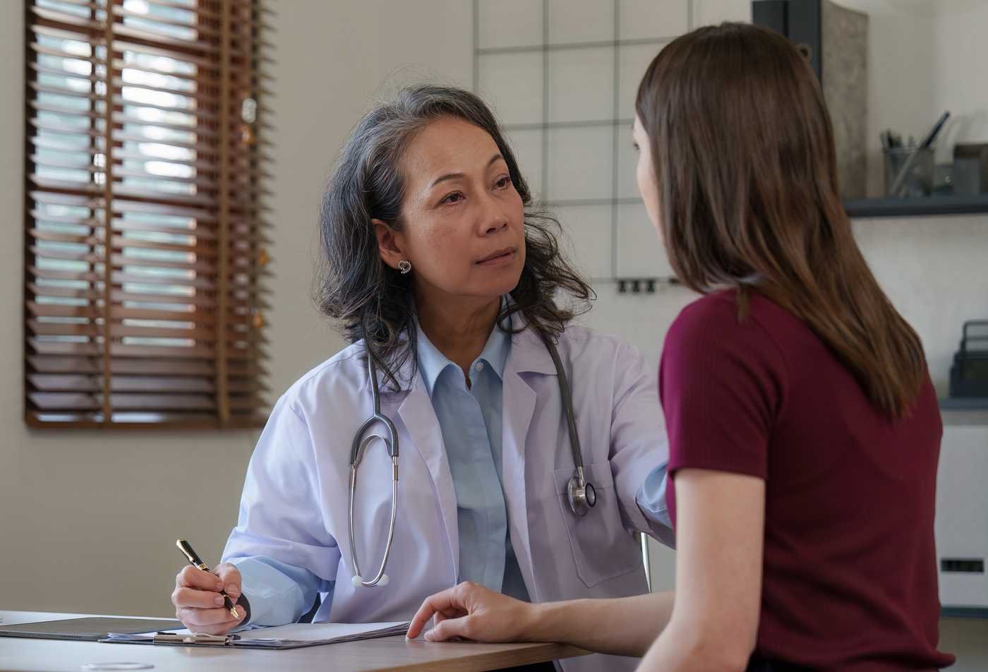 A DNP student consults with a patient during a women's health clinic visit, reflecting the field explored in the Advanced Nursing Practice (Women's Health Nurse Practitioner), DNP.
