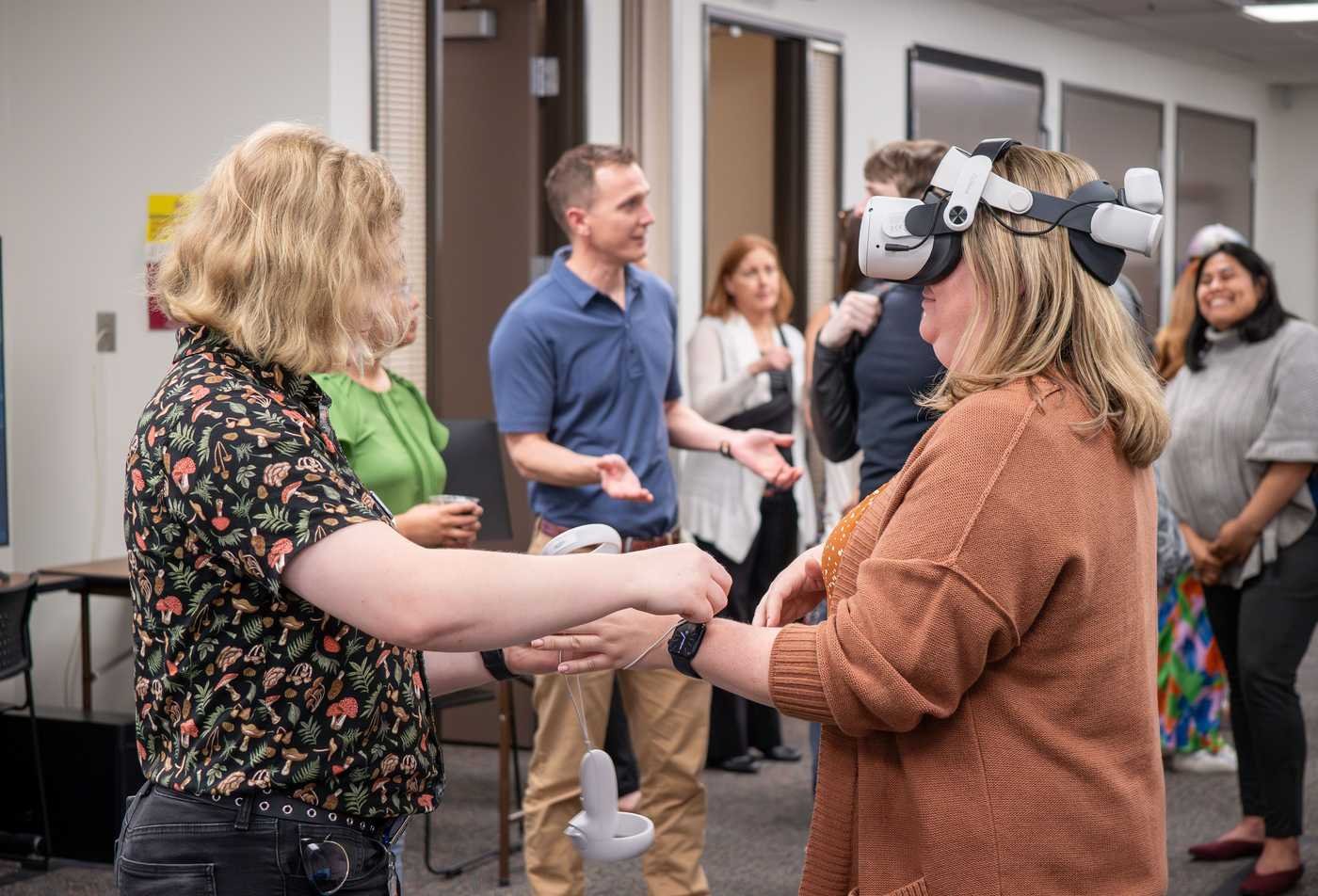 A student guides a participant through a virtual reality demonstration during a health entrepreneurship and innovation learning experience, showcasing hands-on learning in the BAS.