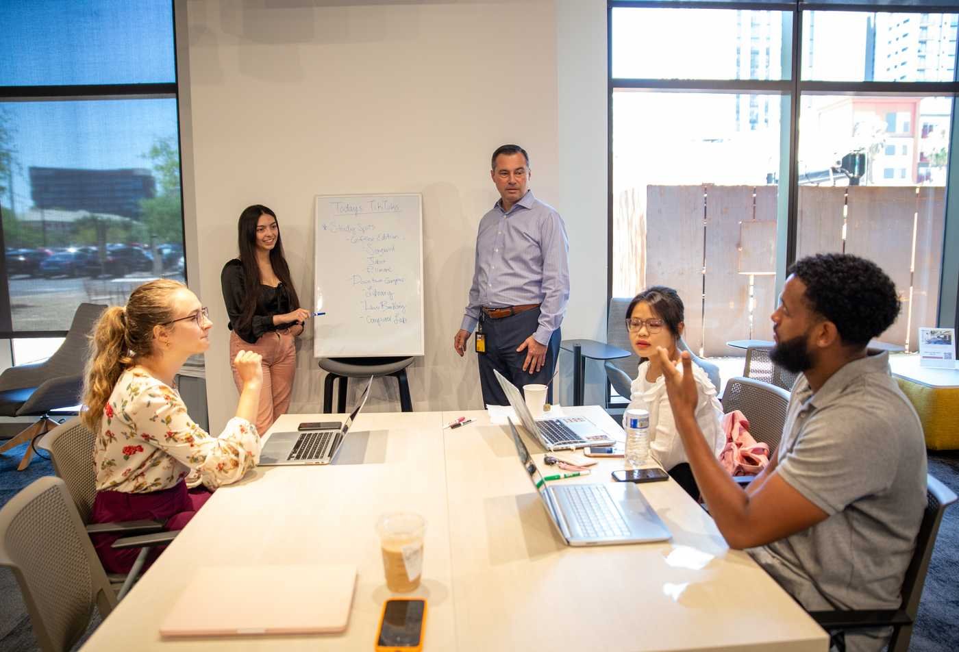 Students gather around a table to learn to identify health care challenges and develop creative, sustainable solutions through entrepreneurship and innovation in the minor in Health Innovation.