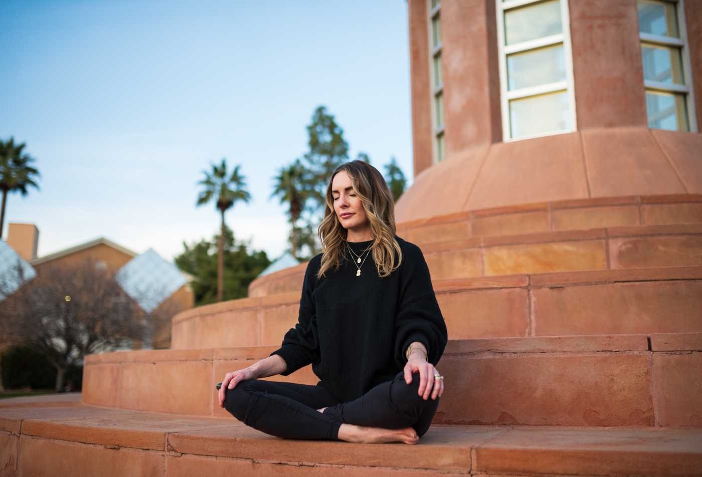 A student sits in meditation on campus as part of wellness practice in the BS in Integrative Health.