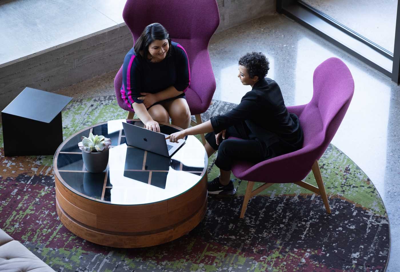 Graduate students engage in discussion in a shared workspace, showcasing collaborative learning in the Innovation Leadership (Graduate Certificate).
