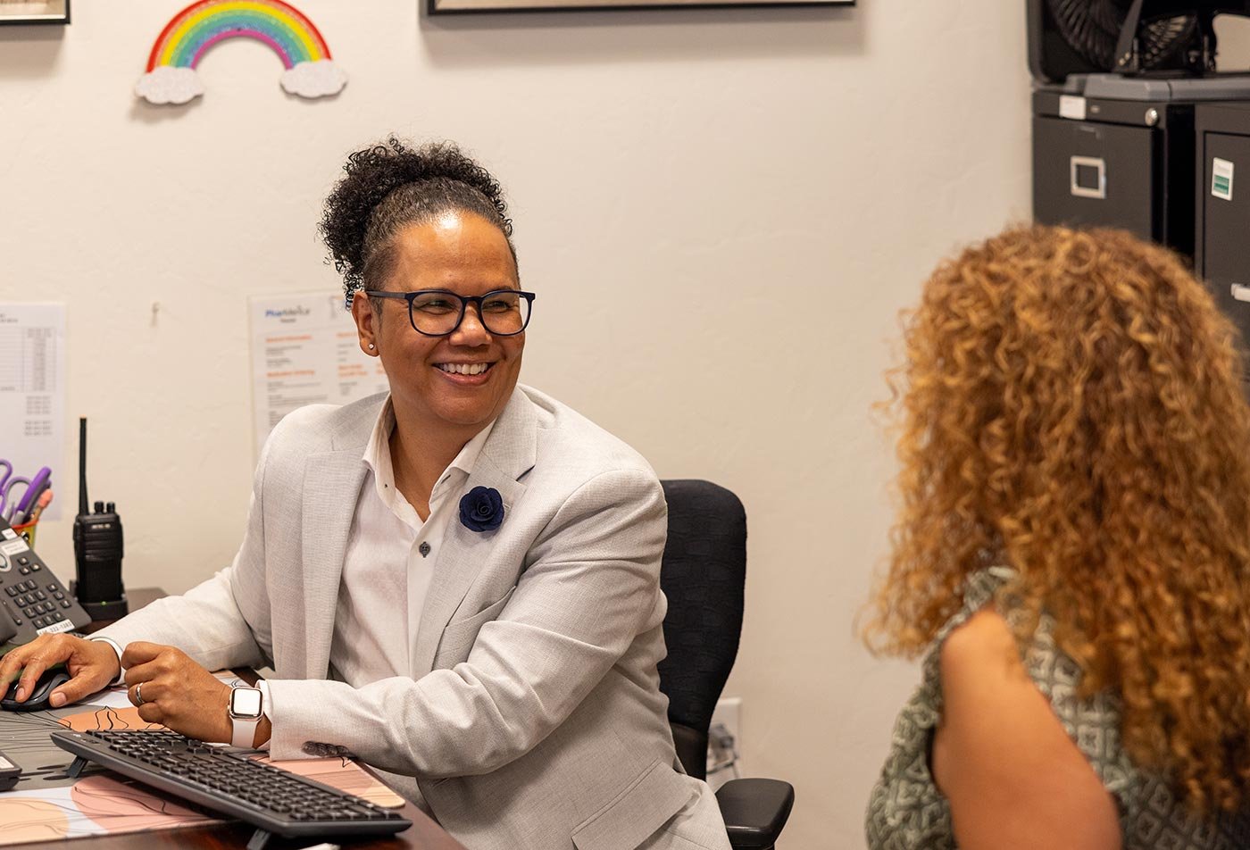 Students talk together in an office setting, reflecting the real-world practice central to ASU's Direct Practice MSW.